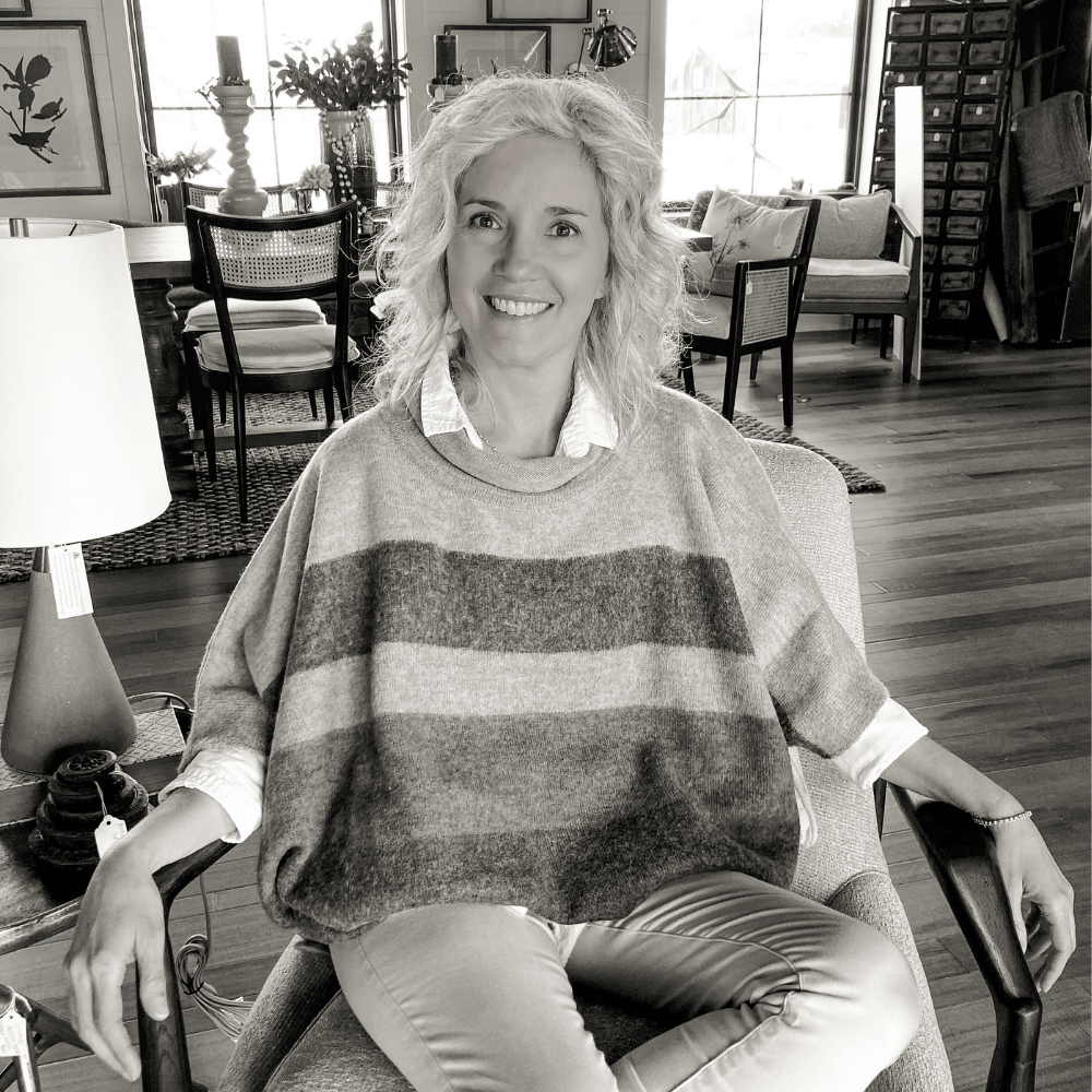 Marta Doster sitting in chair at The Creamery of Roanoke Design Studio